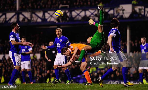 Everton keeper Tim Howard is challenged by Oldham player James Tarkowski during the FA Cup Fifth Round Replay between Everton and Oldham Athletic at...