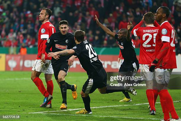 Daniel Caligiuri of Freiburg celebrates his team's third goal with team mate Max Kruse during the DFB Cup Quarter Final match between FSV Mainz 05...