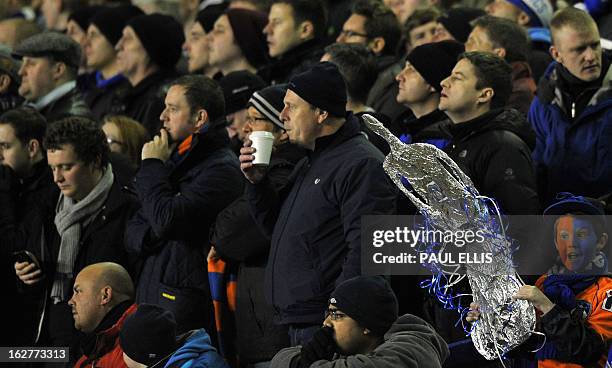 An Oldham fan holds a replica FA Cup in the crowd before before the start of the English FA Cup fifth round replay football match between Everton and...