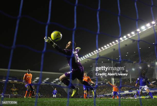 Dean Bouzanis of Oldham Athletic is beaten by Kevin Mirallas of Everton for the opening goal during the FA Cup fifth round replay match between...