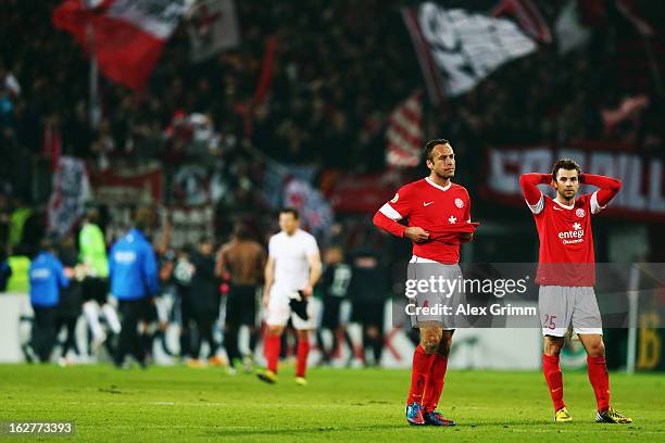 Andreas Ivanschitz and Nikolce Noveski of Mainz react after the DFB Cup Quarter Final match between FSV Mainz 05 and SC Freiburg at Coface Arena on...