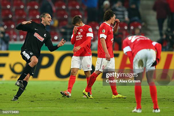 Pavel Krmas of Freiburg celebrates as Marco Caligiuri, Julian Baumgartlinger and Junior Diaz of Mainz react after the DFB Cup Quarter Final match...