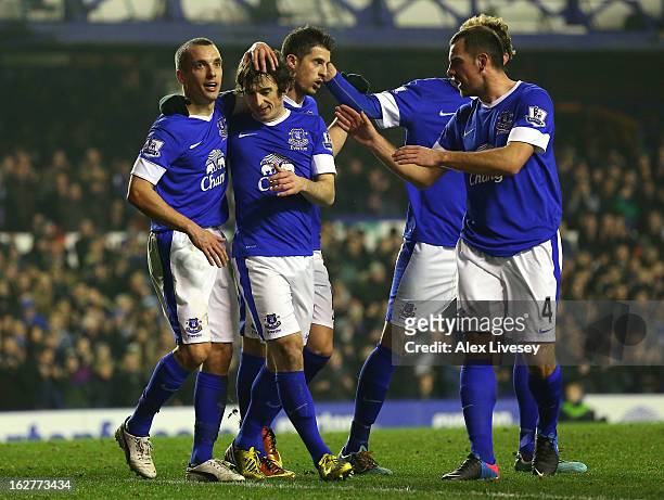 Leighton Baines of Everton celebrates with Leon Osman and team mates after scoring the second goal from the penalty spot during the FA Cup fifth...