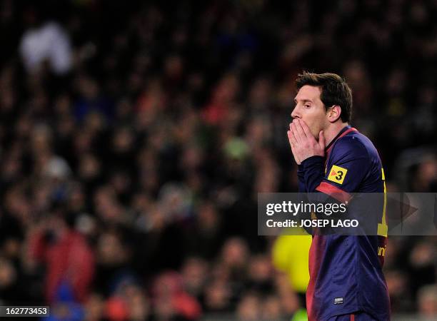 Barcelona's Argentinian forward Lionel Messi reacts during the Spanish Cup semi-final second-leg football match FC Barcelona vs Real Madrid CF at the...