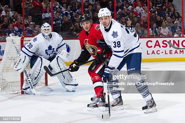 Team mates Ben Scrivens and Frazer McLaren of the Toronto Maple Leafs defend against Jim O'Brien of the Ottawa Senators, during an NHL game at...