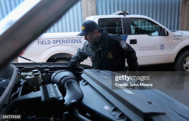 An Office of Field Operations inspector checks a vehicle at a port of entry from Mexico into the United States on February 26, 2013 in Nogales,...