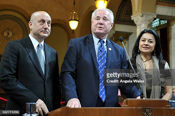 Actor Anupam Kher is presented with the Los Angeles City Proclamation by council member Tom Labonge with author Mira Honeycutt at Los Angeles City...