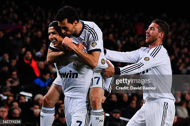 Cristiano Ronaldo of Real Madrid CF celebrates with his team-mates Alvaro Arbeloa and Sergio Ramos after scoring his team's their goal during the...