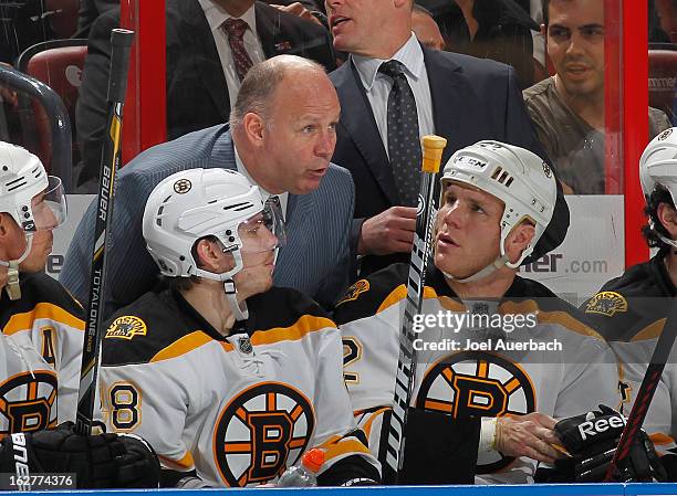 Head coach Claude Julien talks to Shawn Thornton and Chris Bourque of the Boston Bruins during second half action against the Florida Panthers at the...