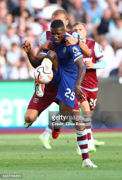 Moises Caicedo of Chelsea is challenged by Tomas Soucek of West Ham United during the Premier League match between West Ham United and Chelsea FC at...