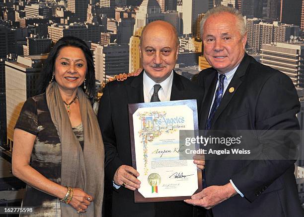 Actor Anupam Kher is presented with the Los Angeles City Proclamation by Councilmember Tom Labonge with author Mira Honeycutt at Los Angeles City...