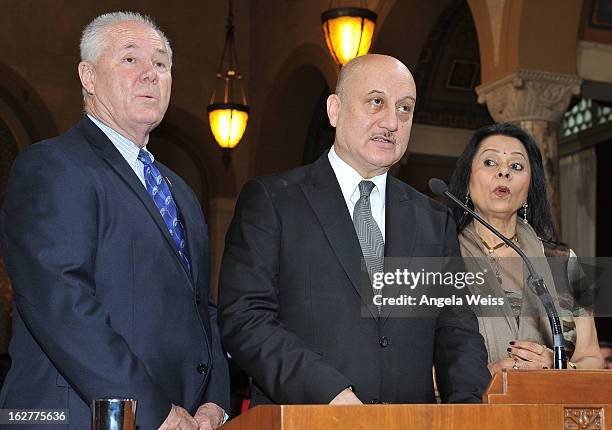 Actor Anupam Kher is presented with the Los Angeles City Proclamation by Councilmember Tom Labonge with author Mira Honeycutt at Los Angeles City...