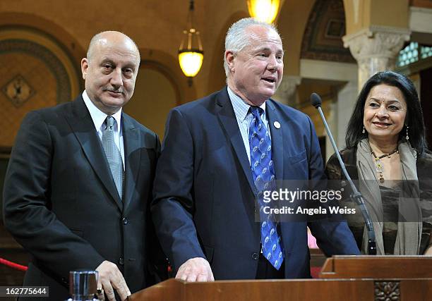 Actor Anupam Kher is presented with the Los Angeles City Proclamation by Councilmember Tom Labonge with author Mira Honeycutt at Los Angeles City...