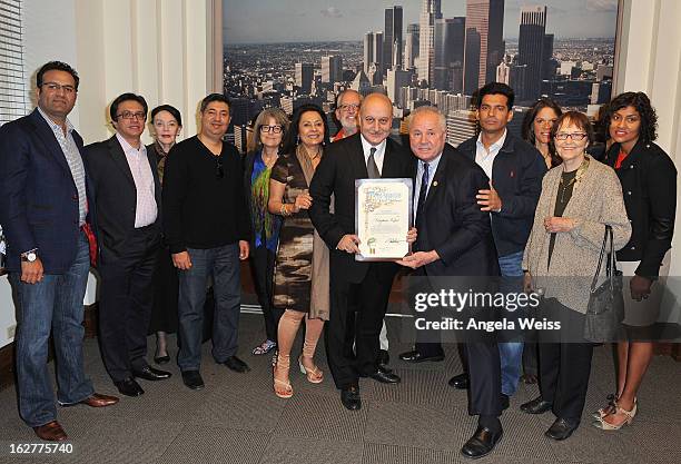 Actor Anupam Kher is presented with the Los Angeles City Proclamation by Councilmember Tom Labonge with author Mira Honeycutt at Los Angeles City...