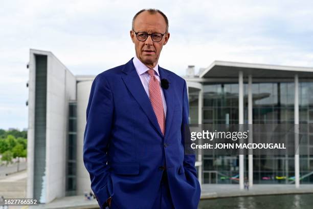 Leader of Germany's Christian Democratic Union Friedrich Merz poses for photos before the recording of his summer interview with German public...