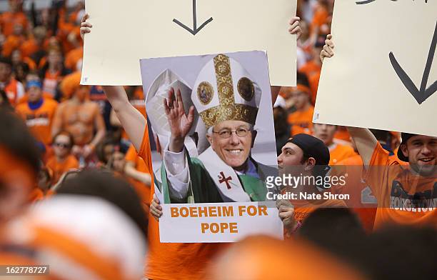 Syracuse Orange fans hold up a poster of head coach Jim Boeheim with the phrase 'Boeheim For Pope' during the game against the Georgetown Hoyas at...