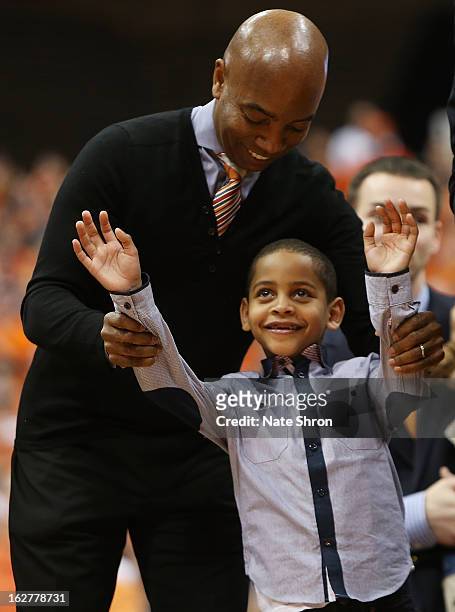 Kiyan Carmelo Anthony cheers with athletic director Daryl Gross of the Syracuse Orange during a half time presentation retiring the jersey of Carmelo...