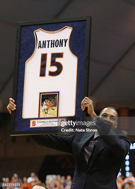Former Syracuse Orange player Carmelo Anthony holds up his jersey as his number is retired during a ceremony at half time during the game against the...