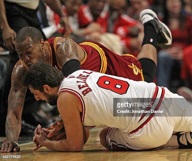 Marco Belinelli of the Chicago Bulls and Marreese Speights of the Cleveland Cavaliers dive for a loose ball at the United Center on February 26, 2013...