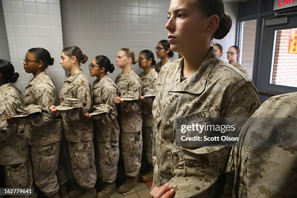 Female Marine recruits stand in line before getting lunch in the chow hall during boot camp on February 26, 2013 at MCRD Parris Island, South...