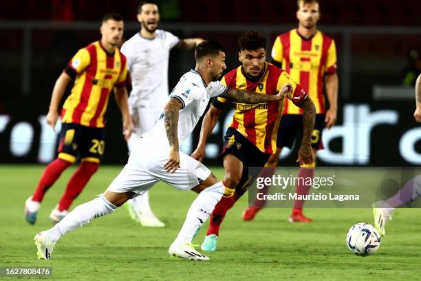 Valentin Gendrey of Lecce competes for the ball with Mattia Zaccagni of Lazio during the Serie A TIM match between US Lecce and SS Lazio at Stadio...