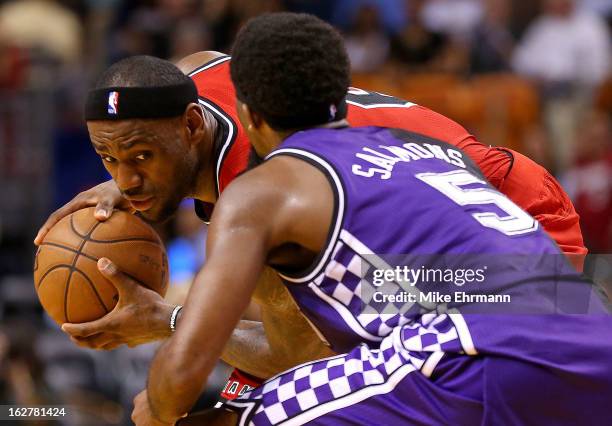 LeBron James of the Miami Heat is guarded by John Salmons of the Sacramento Kings during a game at American Airlines Arena on February 26, 2013 in...