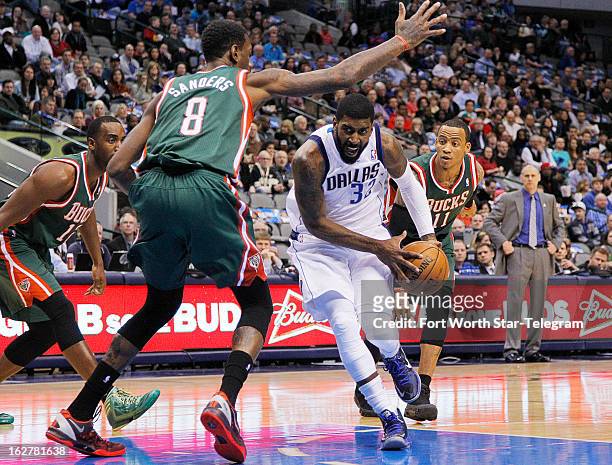 Dallas Mavericks shooting guard O.J. Mayo drives under Milwaukee Bucks center Larry Sanders for a shot in the first half at American Airlines Center...