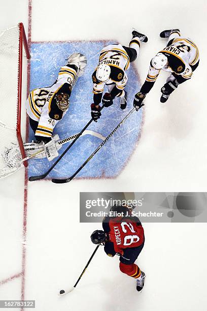 Goaltender Tuukka Rask of the Boston Bruins defends the net with the help of teammates Dougie Hamilton and Zdeno Chara against Tomas Kopecky of the...