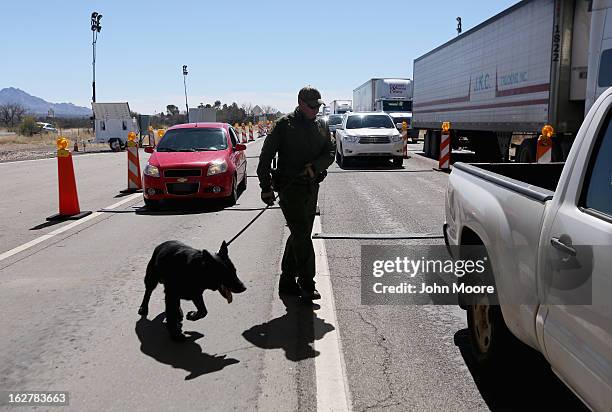 Border Patrol agent and drug sniffing German Shepherd Jack-D prepare to search vehicles for drugs at a checkpoint near the U.S. Mexico border on...