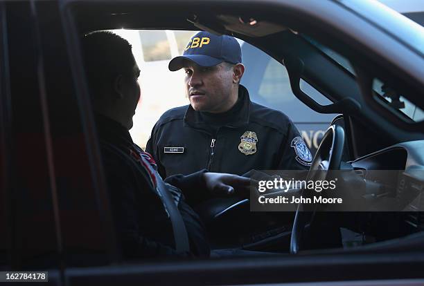 An Customs and Border Protection officer from the U.S. Office of Field Operations , speaks with a motorist crossing from Mexico into the United...