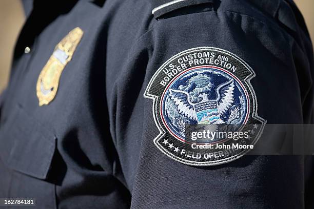 An officer from the U.S. Office of Field Operations , stands near the U.S.-Mexico border on February 26, 2013 in Nogales, Arizona. Some 15,000 people...