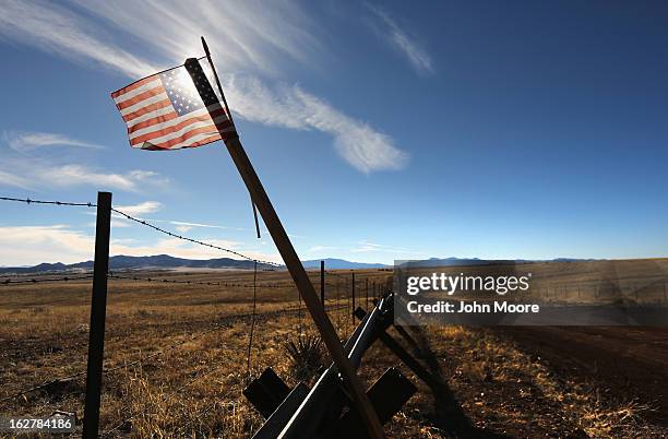 An American flag flies at the U.S.-Mexico border on February 26, 2013 near Sonoita, Arizona. The Federal government has increased the Border Patrol...