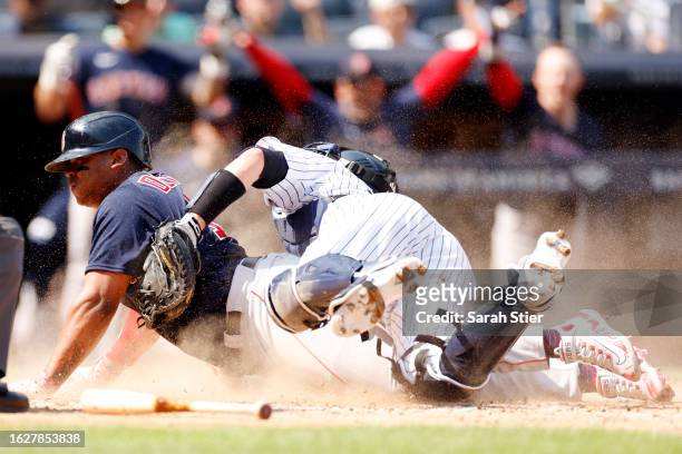 Rafael Devers of the Boston Red Sox slides safely into home ahead of the tag from Kyle Higashioka of the New York Yankees during the sixth inning at...
