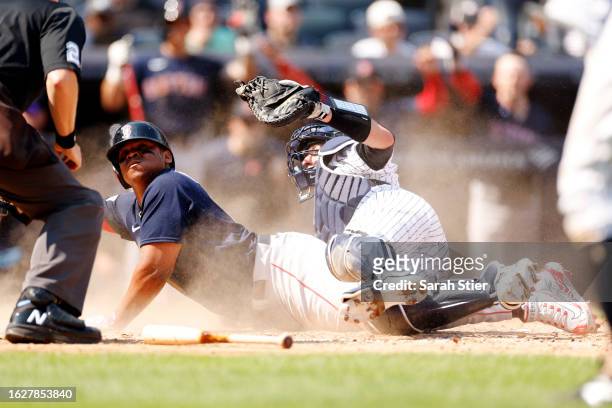 Rafael Devers of the Boston Red Sox slides safely into home ahead of the tag from Kyle Higashioka of the New York Yankees during the sixth inning at...