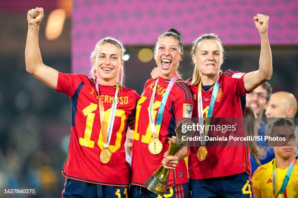 Alexia Putellas of Spain, Jennifer Hermoso of Spain and Irene Paredes of Spain celebrate their victory during the trophy ceremony after the FIFA...