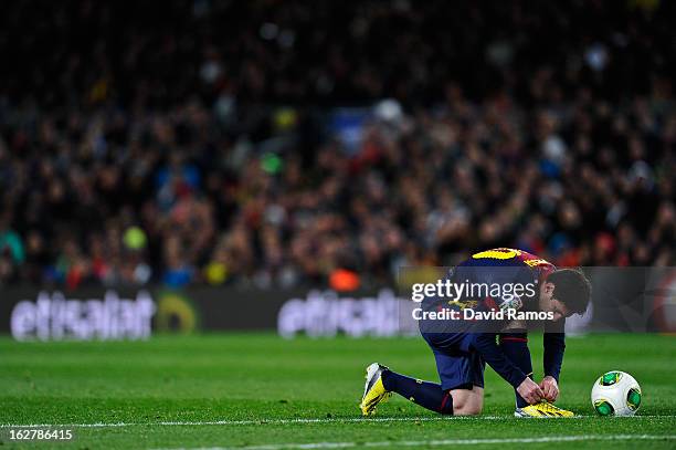 Lionel Messi of FC Barcelona adjust his boots during the Copa del Rey Semi Final second leg between FC Barcelona and Real Madrid at Camp Nou on...
