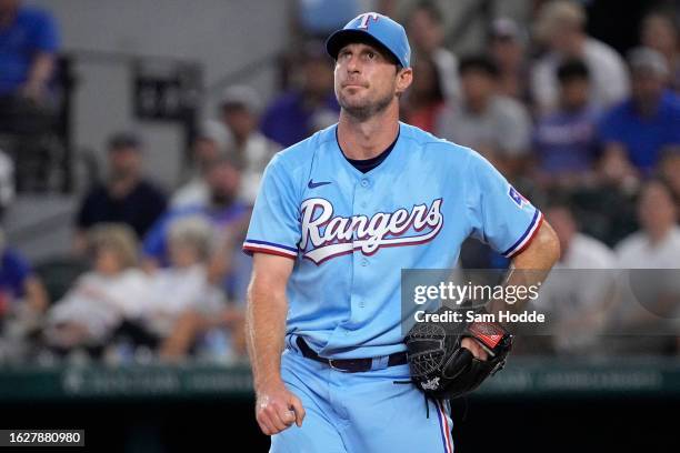 Max Scherzer of the Texas Rangers watches the flight of a fly ball during the third inning against the Milwaukee Brewers at Globe Life Field on...