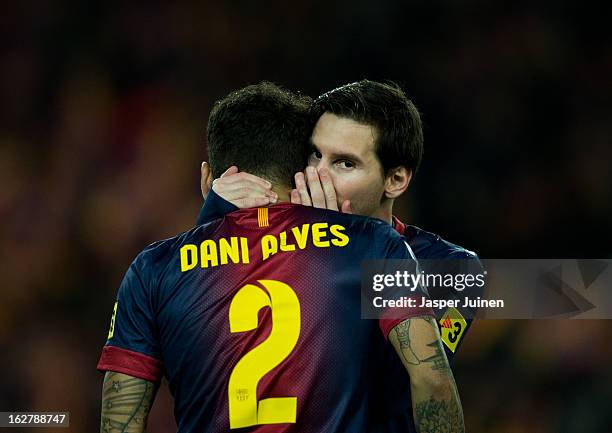 Lionel Messi of Barcelona chats to his teammate Daniel Alves at the start of the Copa del Rey semi final second leg match between FC Barcelona and...