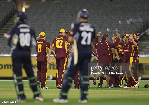 The Bulls celebrate after winning the Ryobi One Day Cup final as the Bushrangers batsman look on after the Ryobi One Day Cup final match between the...