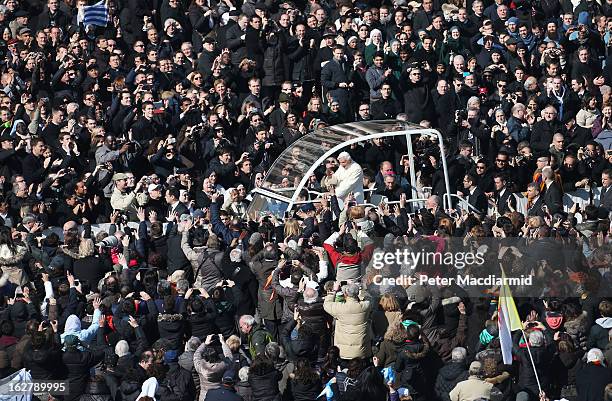 Pope Benedict XVI waves to the faithful from the Popemobile as he arrives in St Peter's Square on February 27, 2013 in Vatican City, Vatican. The...