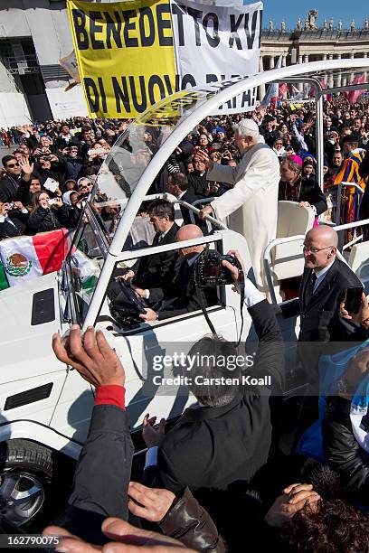 Pope Benedict XVI travels through the crowd in the popemobile in St Peter's Square on February 27, 2013 in Vatican City, Vatican. The Pontiff will...