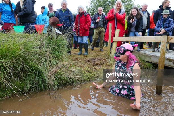 Competitor reacts upon entering the water to take part in the World Bog Snorkelling Championships held at the Waen Rhydd peat bog, Llanwrtyd Wells,...