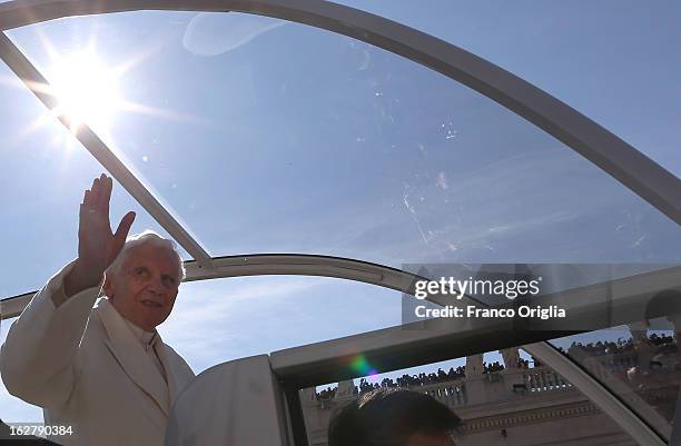 Pope Benedict XVI waves to the faithful as he arrives in St Peter's Square for his final general audience on February 27, 2013 in Vatican City,...