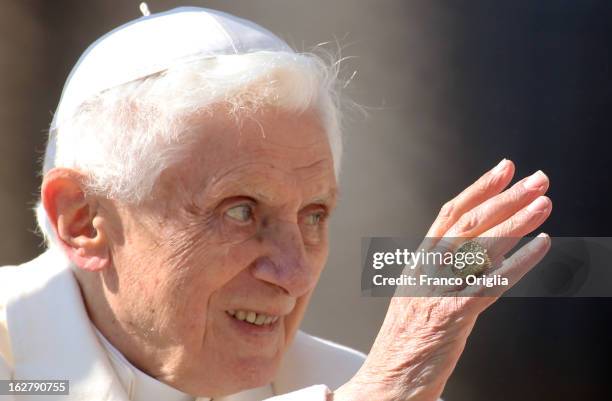 Pope Benedict XVI waves to the faithful as he leaves St Peter's Square at the end of his final general audience on February 27, 2013 in Vatican City,...