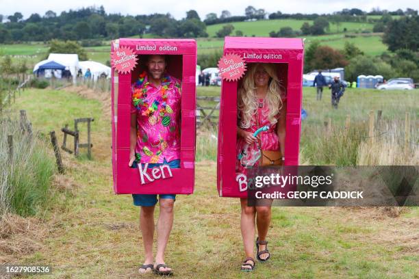 Competitors dressed as Barbie and Ken arrive to the World Bog Snorkelling Championships held at the Waen Rhydd peat bog, Llanwrtyd Wells, Mid Wales,...