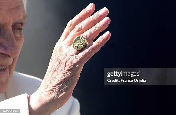 Pope Benedict XVI waves to the faithful as he leaves St Peter's Square at the end of his final general audience on February 27, 2013 in Vatican City,...
