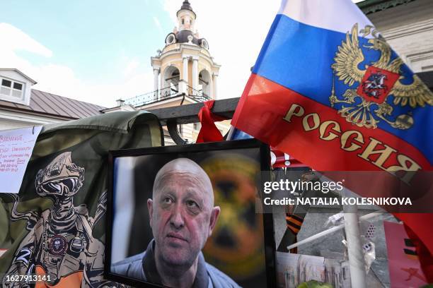 This photograph taken on August 27 shows a portrait of late head of Wagner paramilitary group, Yevgeny Prigozhin displayed at a makeshist memorial in...