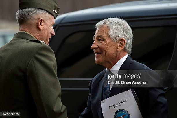 New Secretary of Defense Chuck Hagel is greeted by USMC Lt. General Thomas Waldhauser, who will serve as Hagel's Senior Private Military Assistant,...