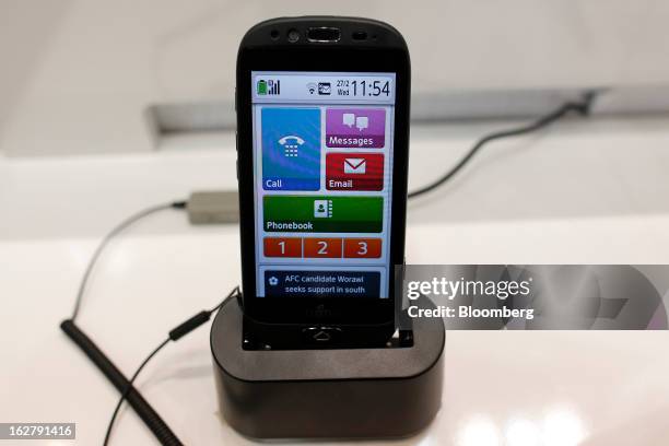 Stylistic S01 smartphone sits in a charging dock in the Fujitsu Ltd. Pavilion at the Mobile World Congress in Barcelona, Spain, on Wednesday, Feb....