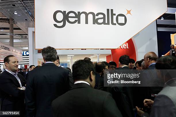 Visitors gather in the Gemalto NV pavilion at the Mobile World Congress in Barcelona, Spain, on Wednesday, Feb. 27, 2013. The Mobile World Congress,...